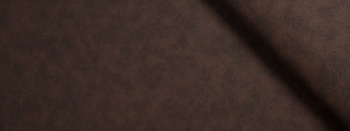 Brown suede-like upholstery fabric close-up with a dark diagonal seam.