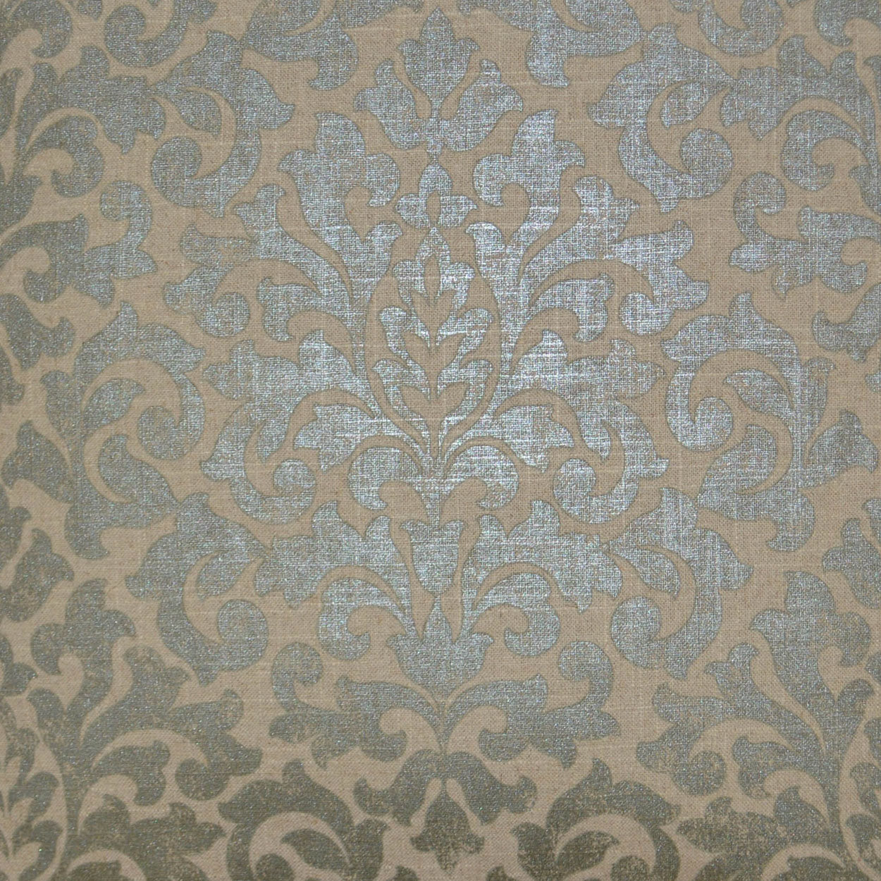 Damask patterned upholstery fabric in pale blue-gray on warm beige with metallic sheen.