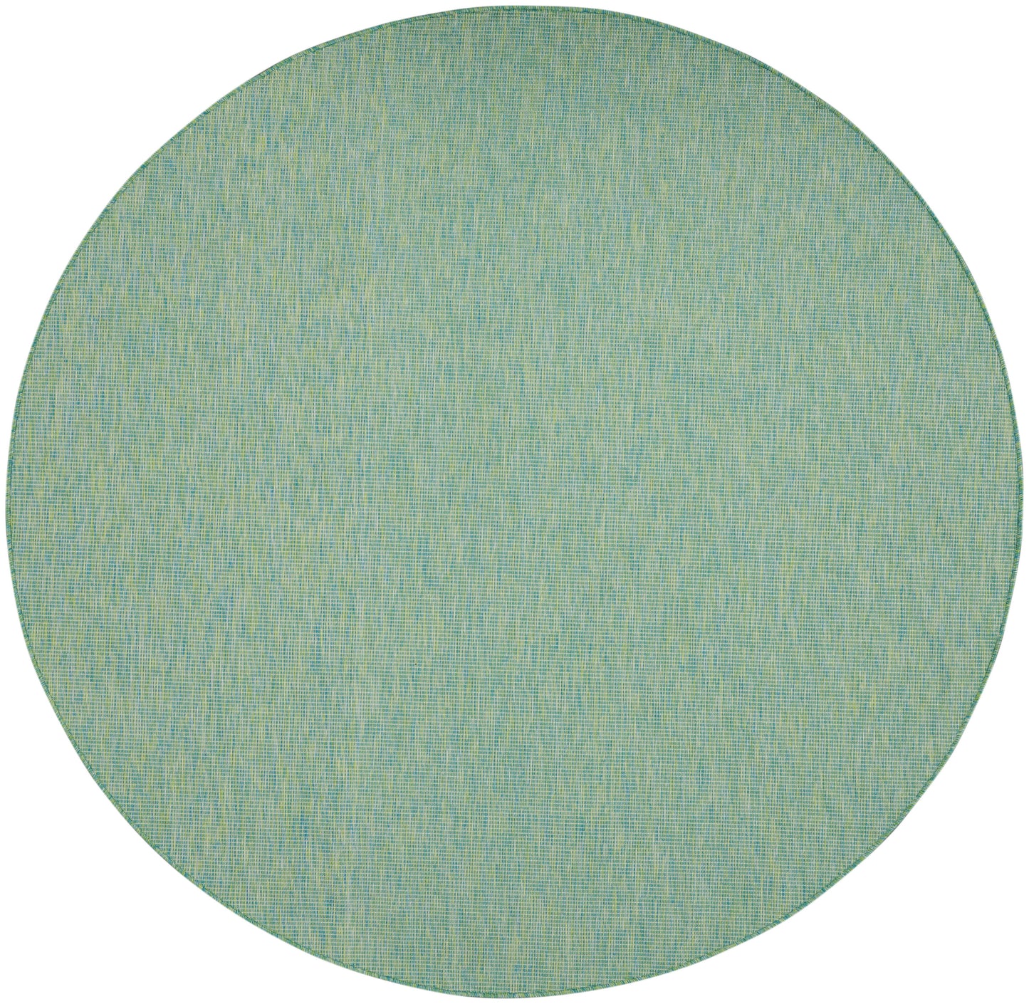 Round teal-green woven rug with pale yellow flecking; casual coastal living room accent.