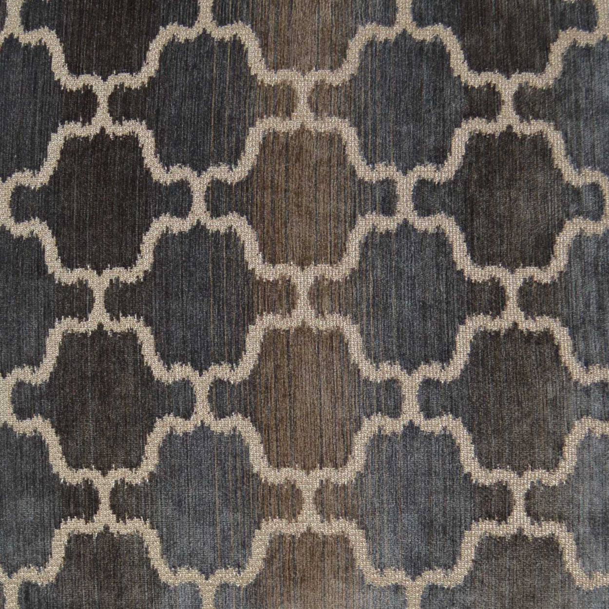 Navy and beige rug with cream interlocking quatrefoil lattice pattern; woven textile.