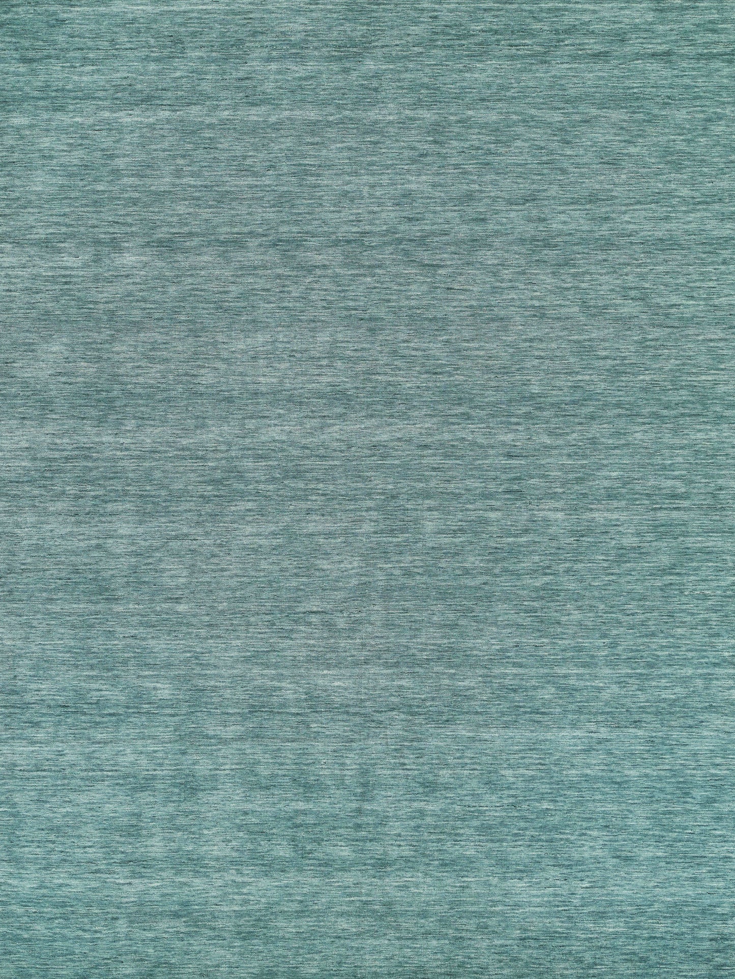 Teal heathered hand-loomed rug with subtle melange fibers; soft and cozy.