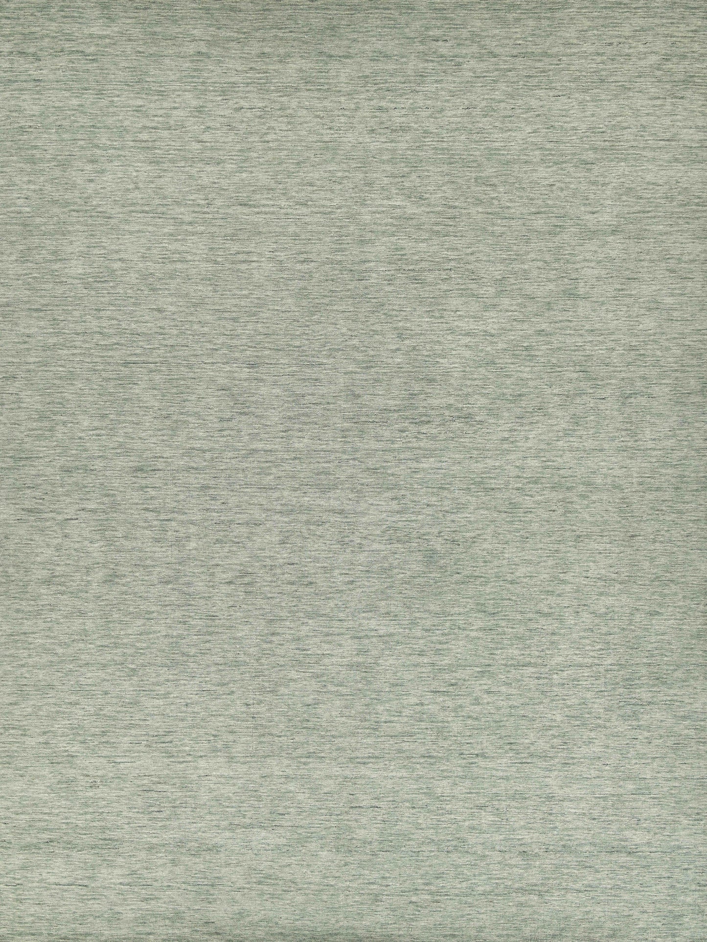 Sage green hand-loomed rug with soft, interwoven fibers; 2' x 3'.