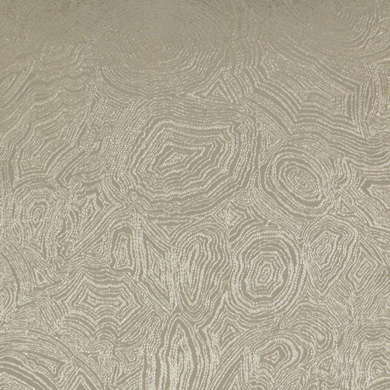 Beige jacquard fabric with embossed circular/topographic rings; decorative upholstery or drapery textile.
