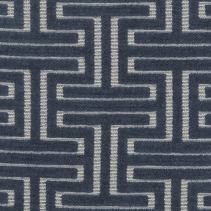 Navy blue woven upholstery fabric with white Greek-key meander pattern; geometric interlocking motif and fabric texture.