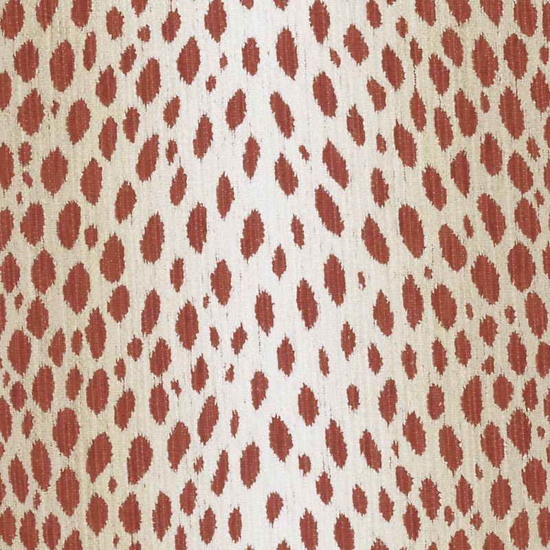 Beige fabric close-up with red-brown leopard-like spots; bold animal-print pattern.