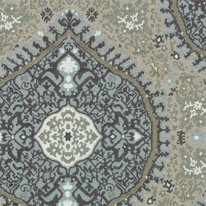 Muted blue and beige ornate upholstery fabric pattern with a central medallion and intricate floral motif.