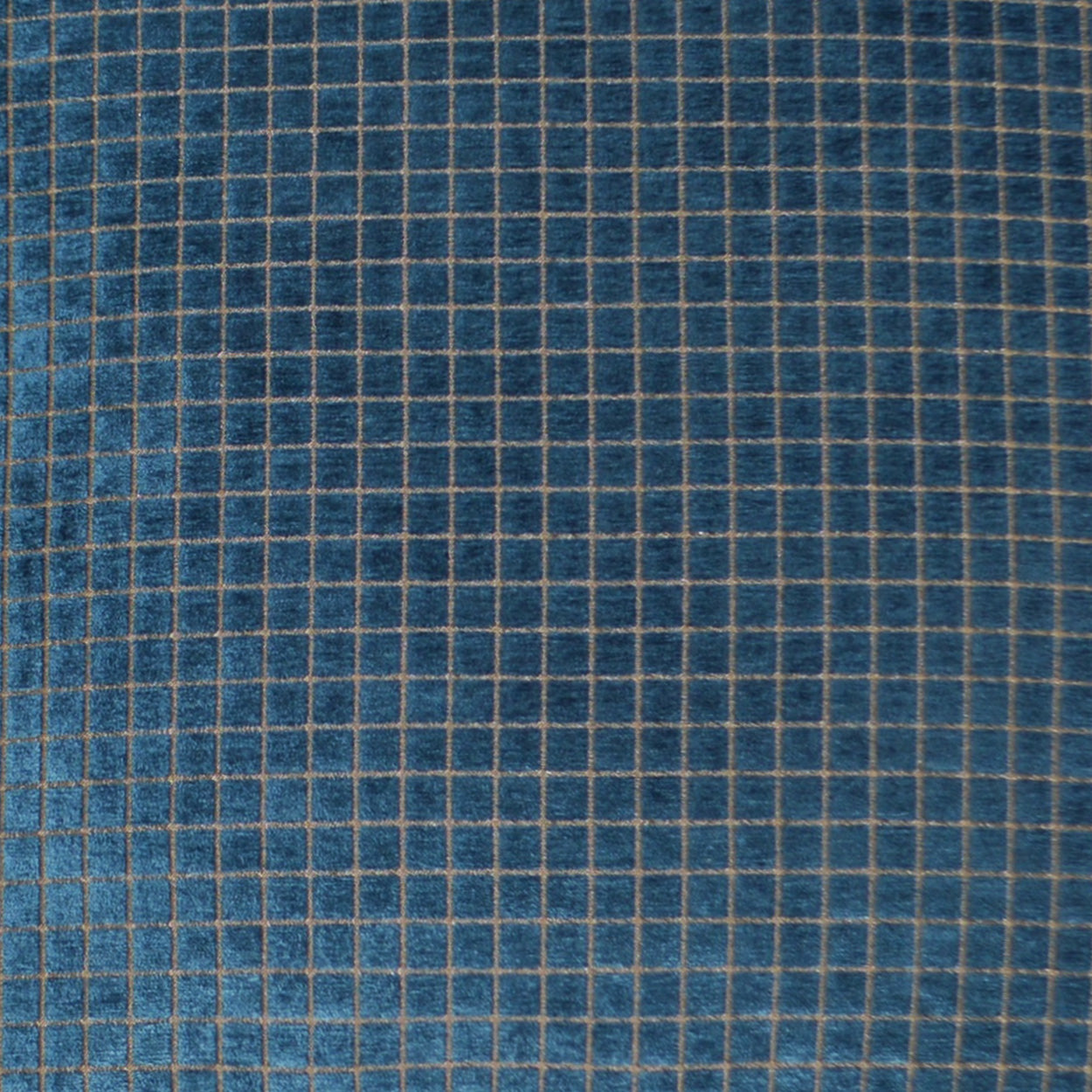 Blue fabric with a beige grid pattern of small squares, denim-inspired textile.
