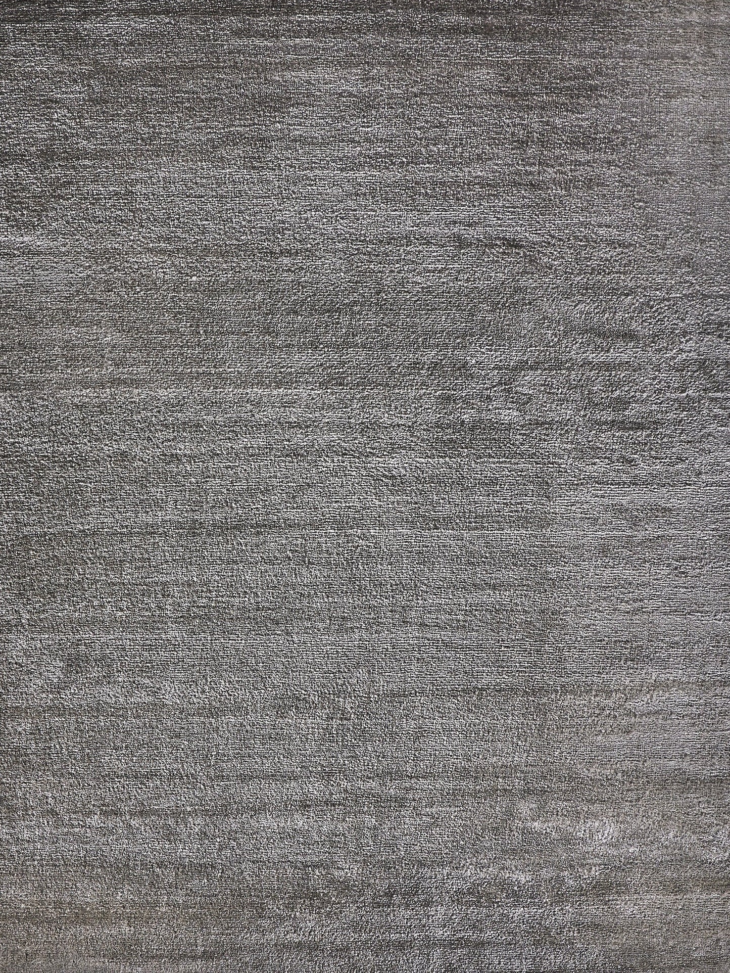Textured gray handloomed rug with a soft, plush pile.