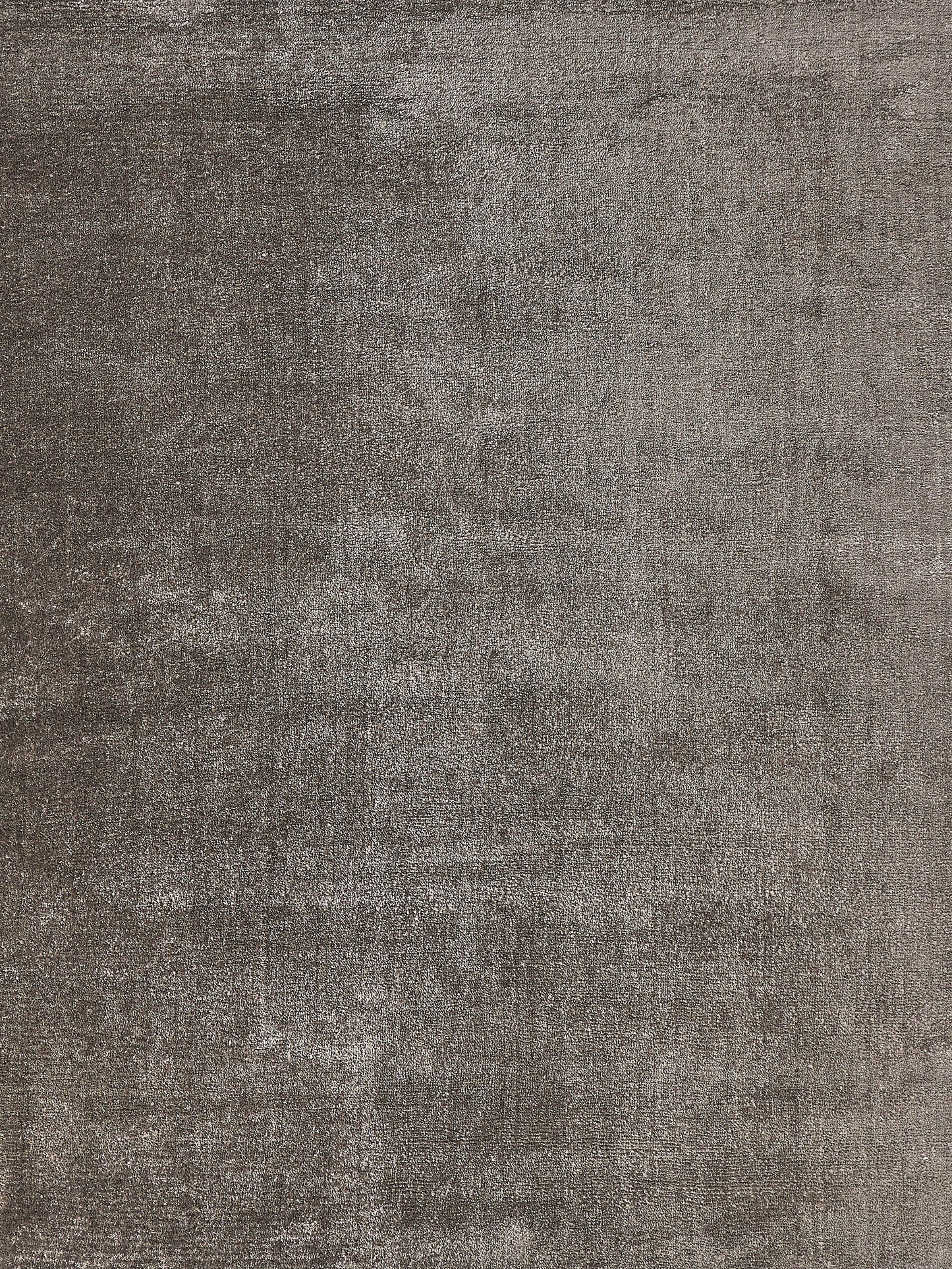 Textured area rug in shades of grey, featuring a soft, plush surface and a modern, minimalist design. Ideal for contemporary decor.