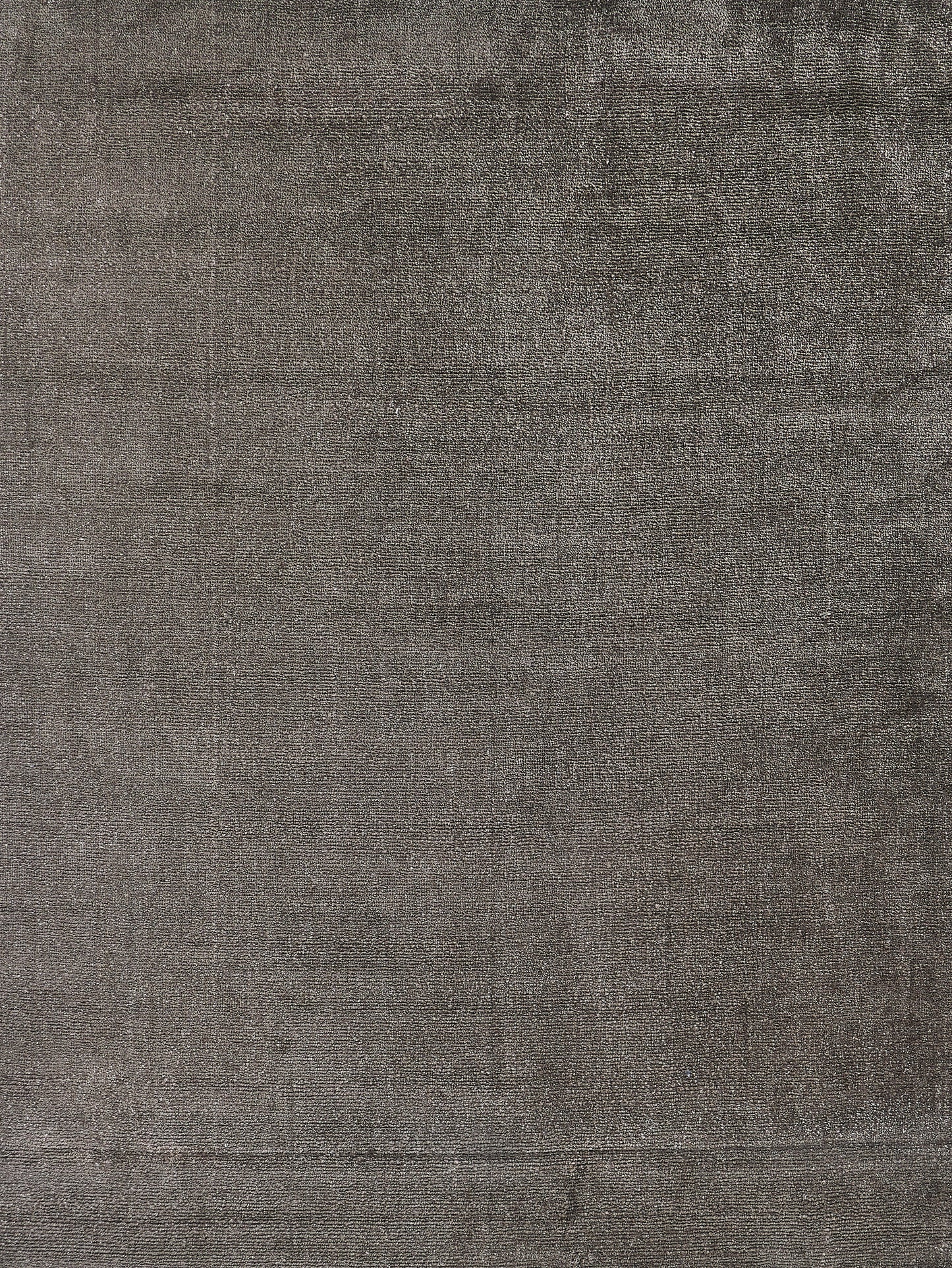 Luxurious dark gray handloomed rectangle rug with a plush, soft texture.