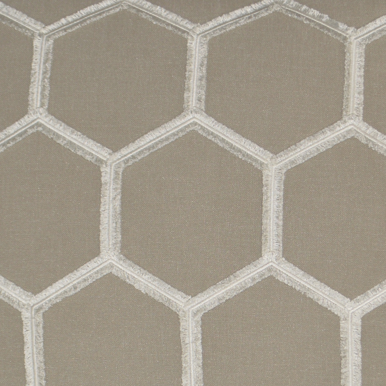 Taupe fabric with white hexagon lattice embroidery; geometric honeycomb pattern.