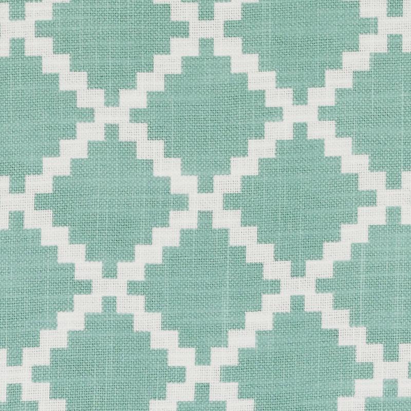 Teal woven fabric with white stepped diamond lattice pattern; geometric ikat-style textile for decor.