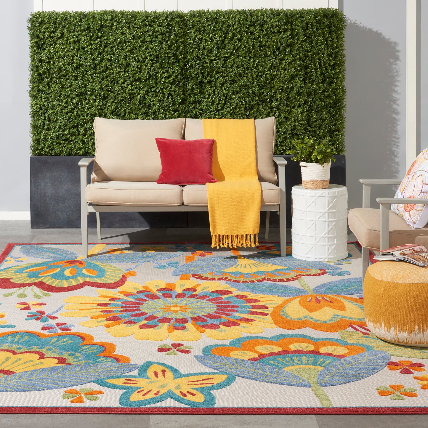 Vibrant floral rug in an outdoor setting with greenery in the background.