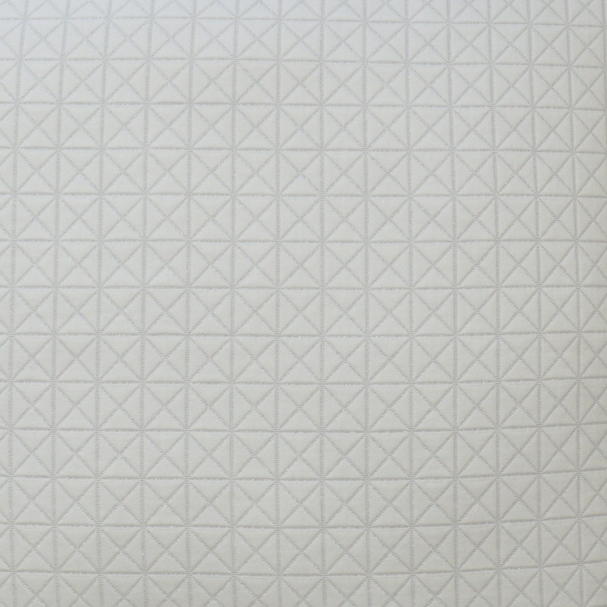 Light gray fabric with a geometric diamond/star quilt pattern, a soft textile for upholstery or home decor.