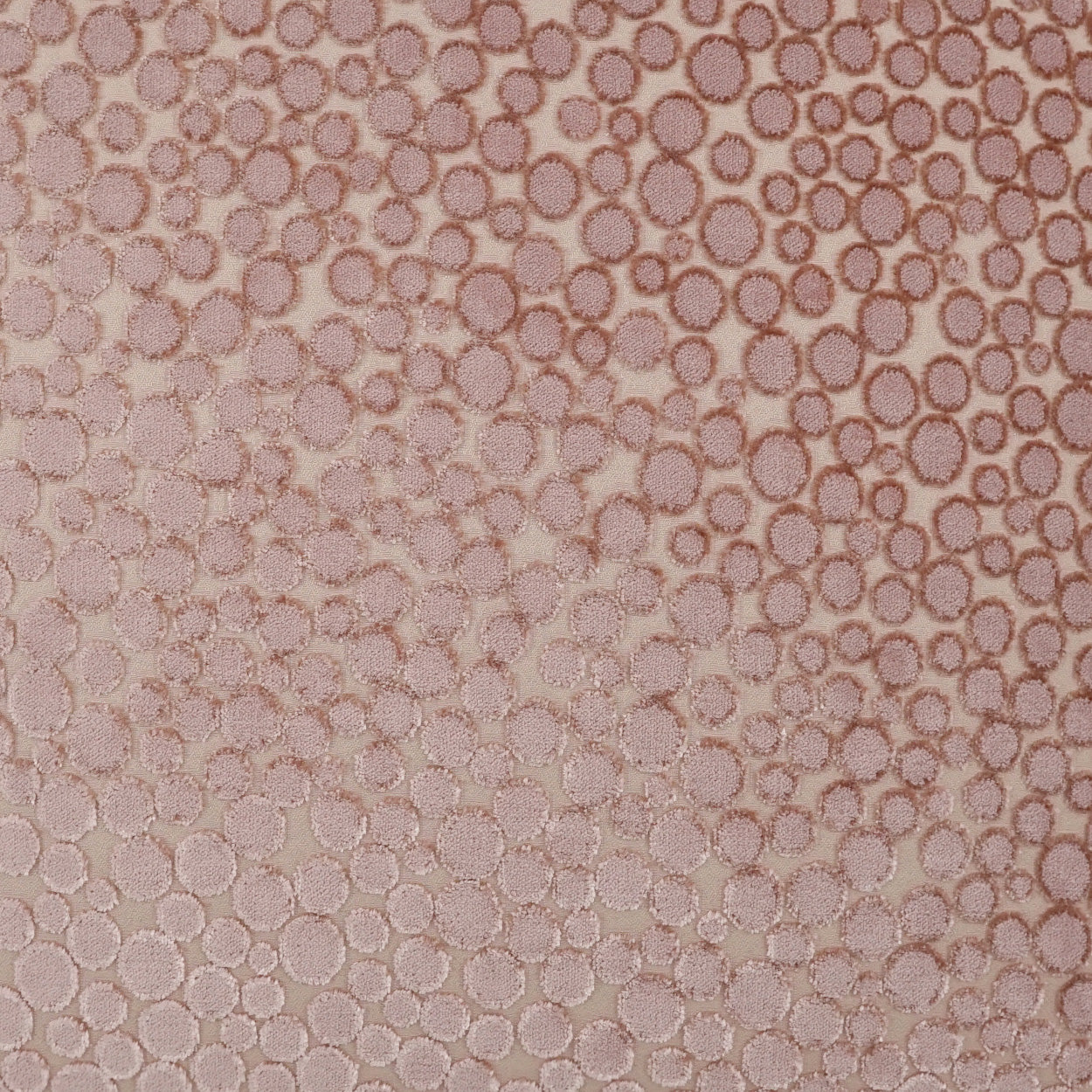 Blush textured 24 x 24 inch pillow with a circular dot pattern.