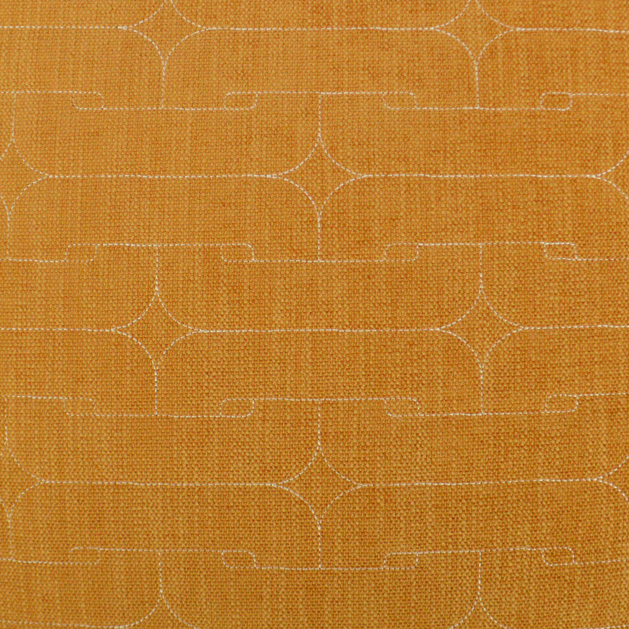 Mustard orange woven fabric with white stitched geometric lattice of curved lines.