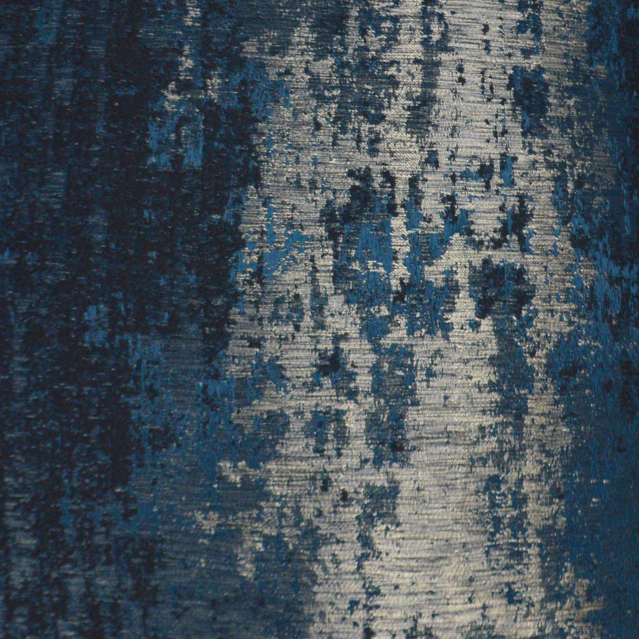 Blue-toned, distressed abstract woven rug fabric with navy & gray-blue hues and textured weave.