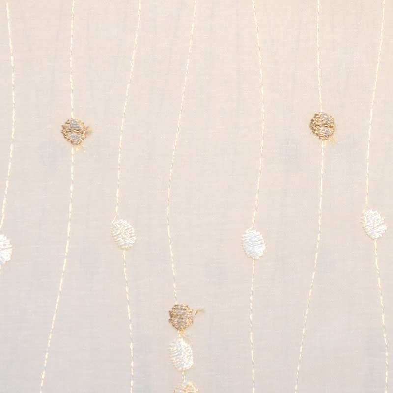 Beige drapery fabric with vertical wavy lines in gold and white and small leaf-shaped appliqués.