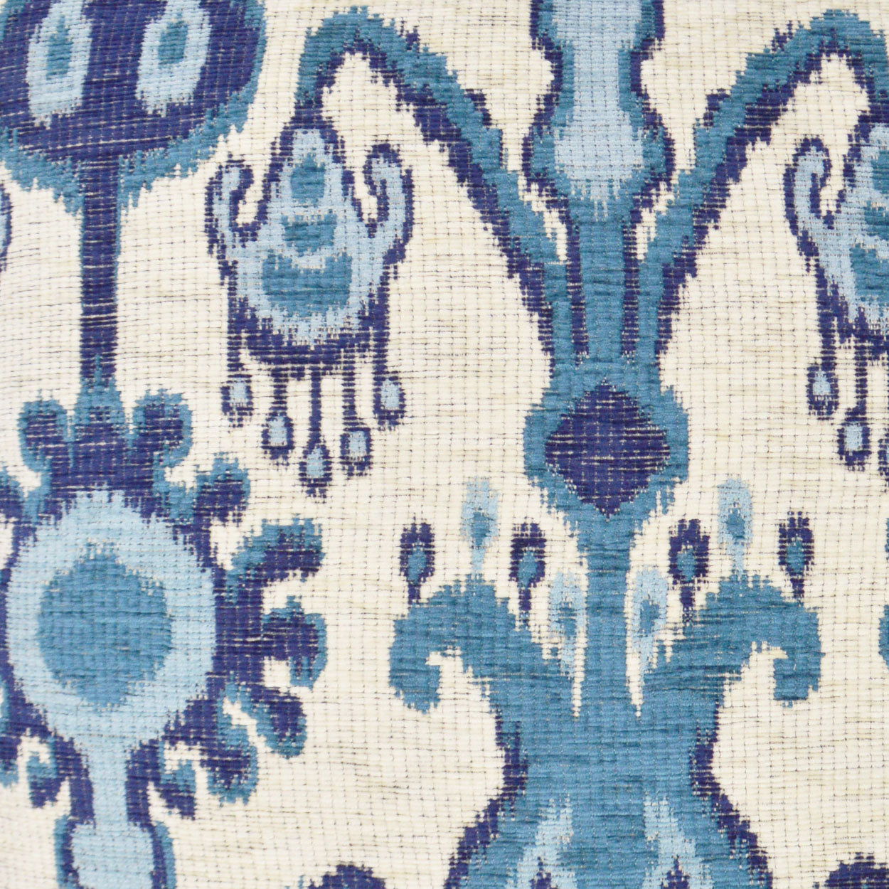 Ivory damask fabric with ornate blue and teal floral motifs; woven textile with vintage elegance.