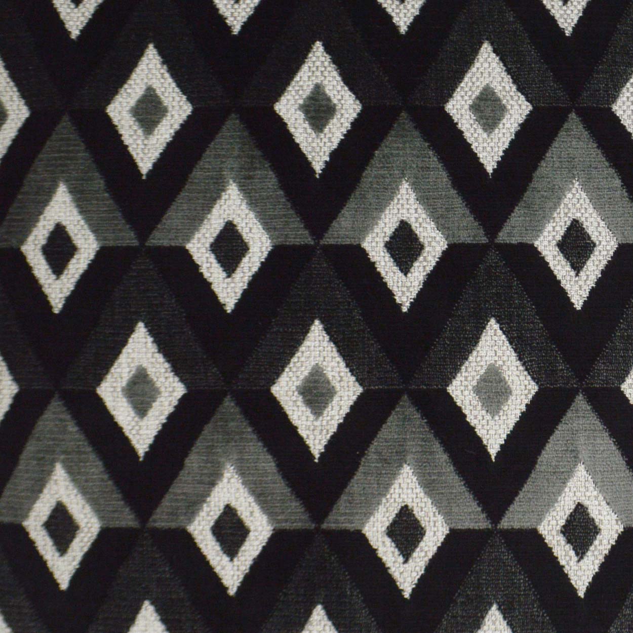 Pillow with geometric diamond-pattern in black, charcoal, light gray and white; 24" x 24