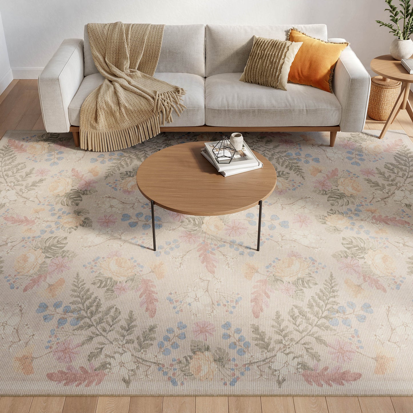 Cozy living room with light gray sofa, beige throw, orange and striped cushions, round wood coffee table, pastel floral rug.