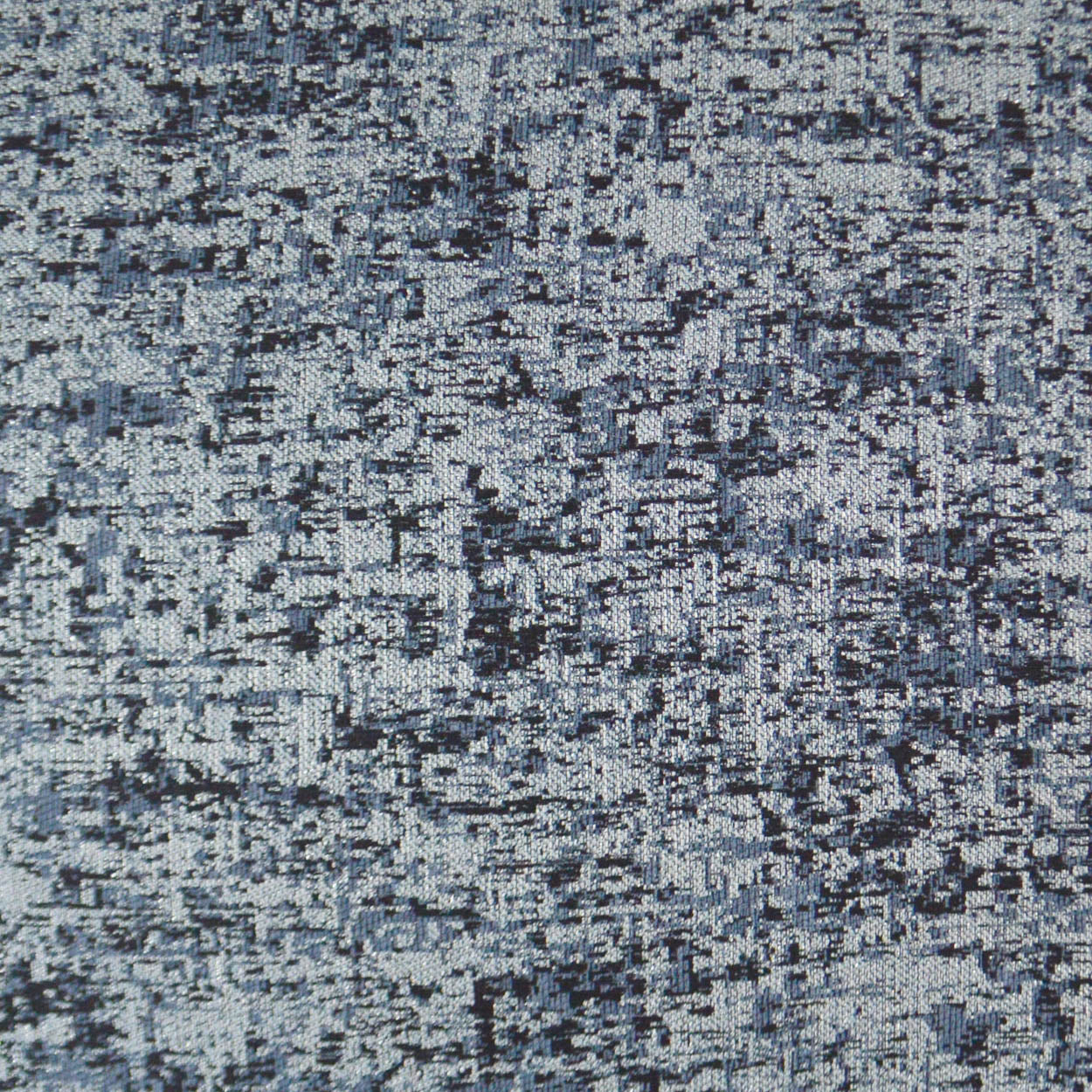 Blue-gray speckled fabric texture with abstract woven pattern, suitable for upholstery or rug applications.