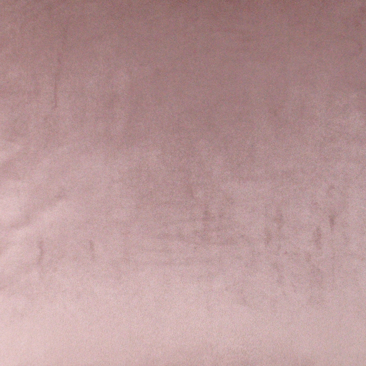 Dusty pink velvet fabric texture with soft, plush surface.
