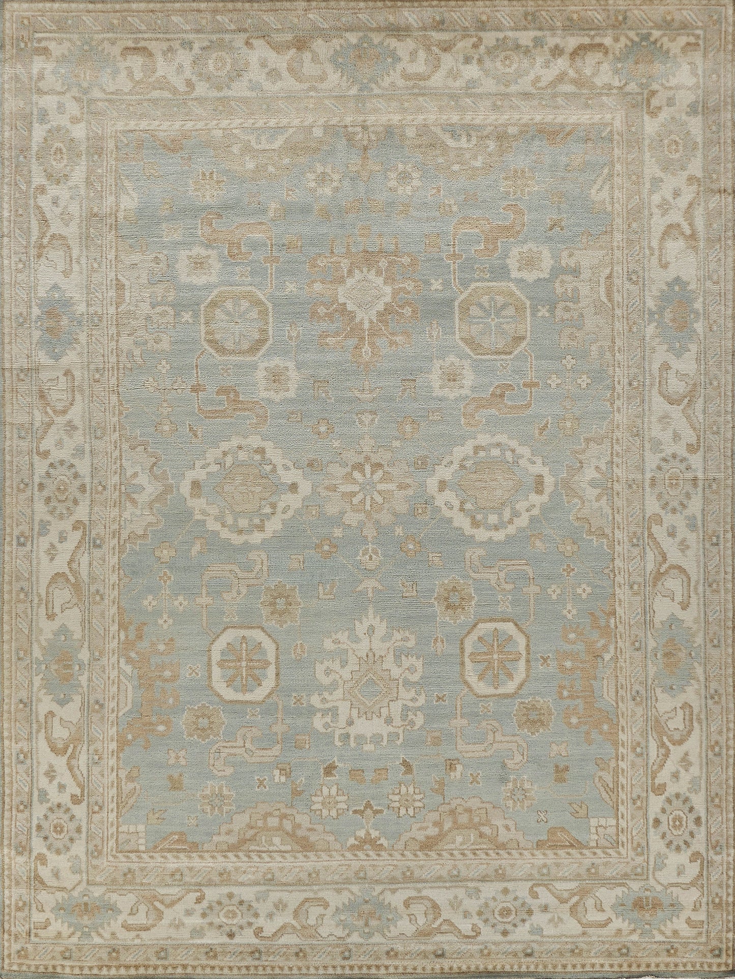 Pale blue field rug with ivory floral medallion, ivory border and geometric motifs, vintage oriental style.