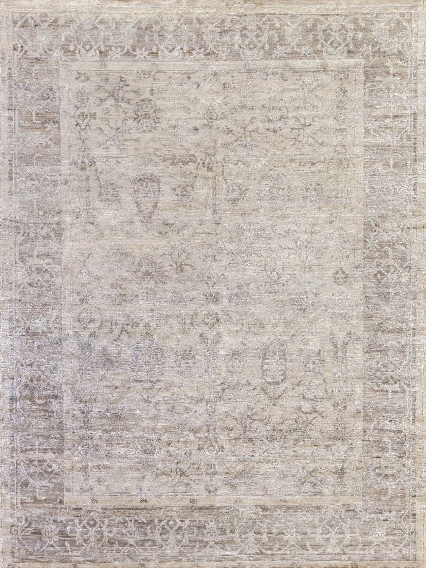 Neutral-toned, hand-knotted rectangular area rug with intricate floral patterns and a faded vintage style. Soft, subtle textures.