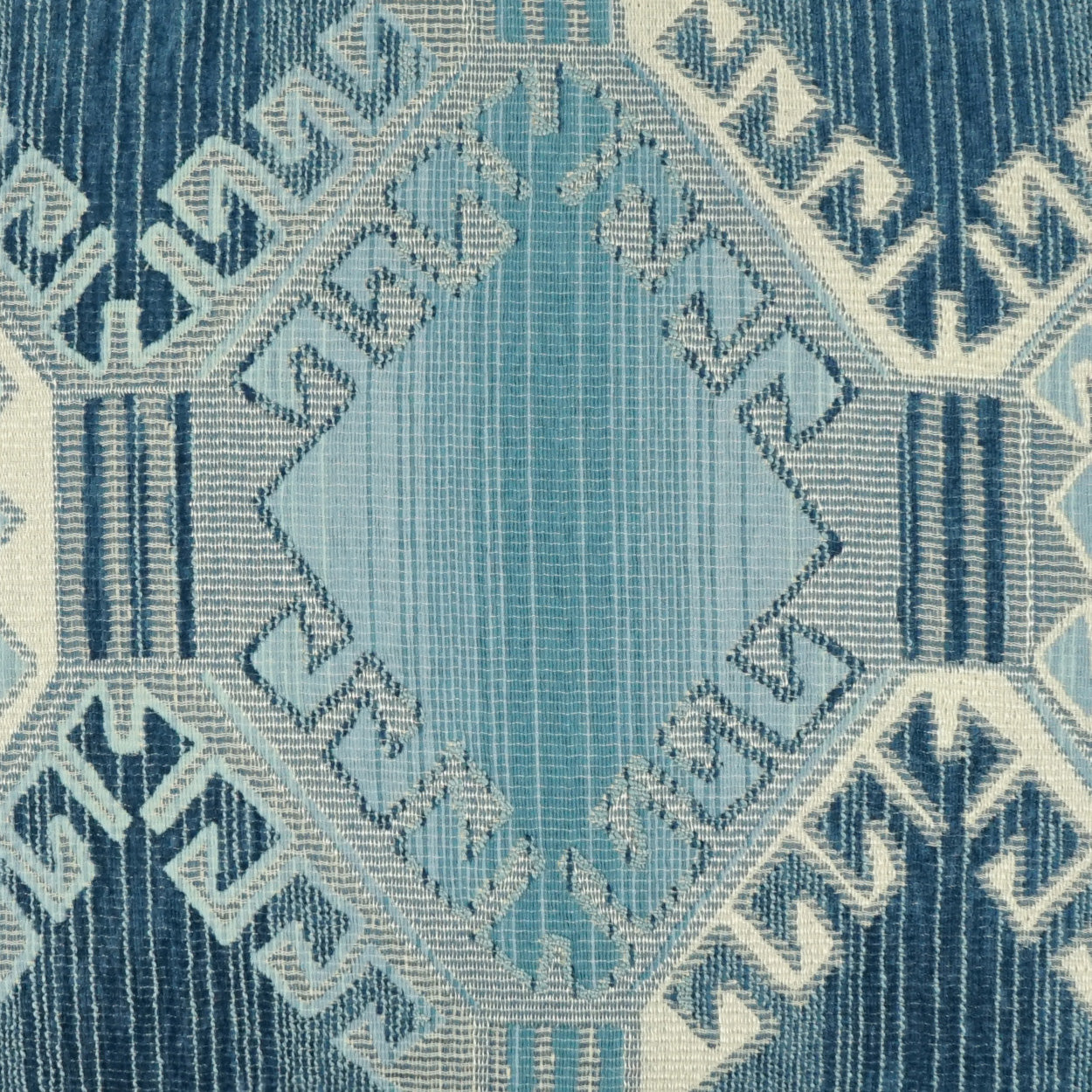 Blue geometric woven rug with a central light-blue diamond medallion and Greek-key border.