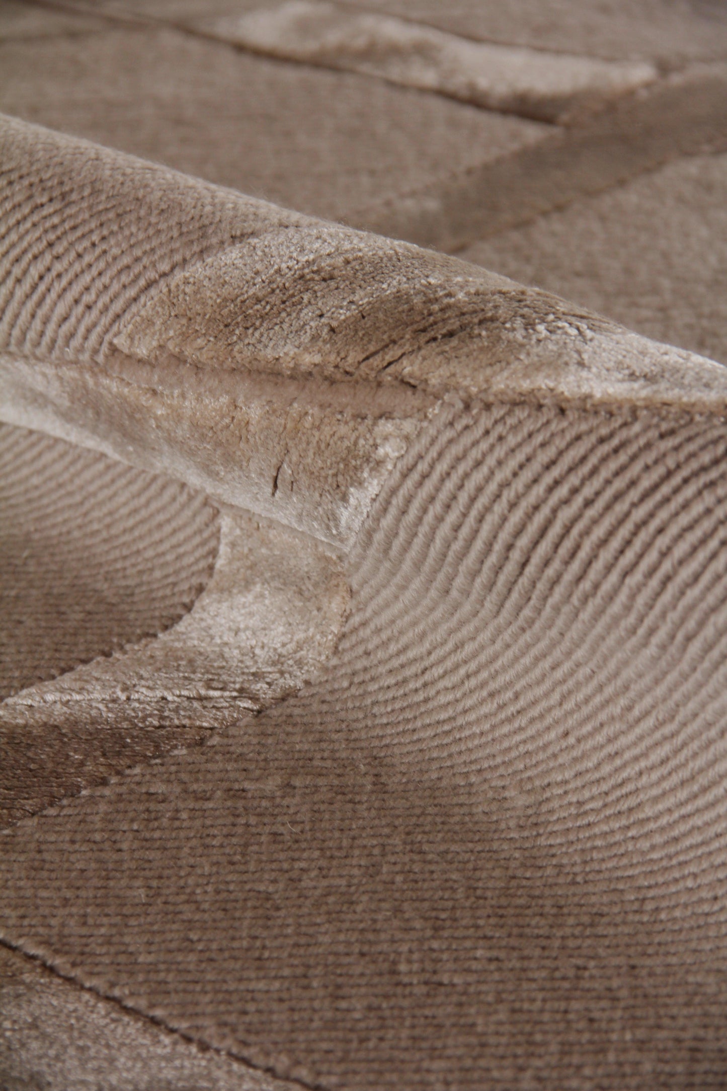 Beige velvet rug close-up showing plush pile and hand-knotted texture