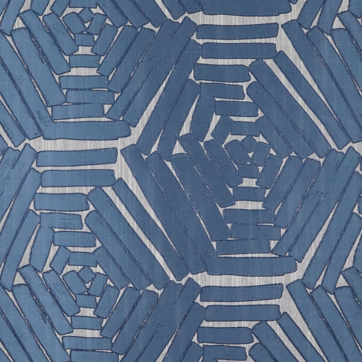 Blue woven fabric with interlocking hex pattern in denim blues; modern geometric textile for decor or apparel.