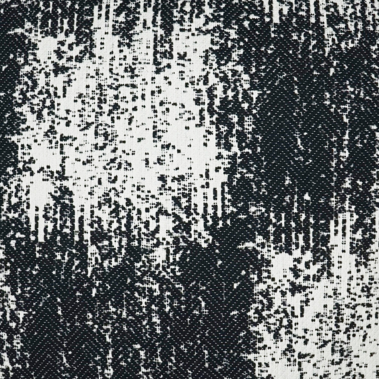 Close-up of black and white woven fabric with irregular vertical pattern; textured textile for upholstery or apparel.