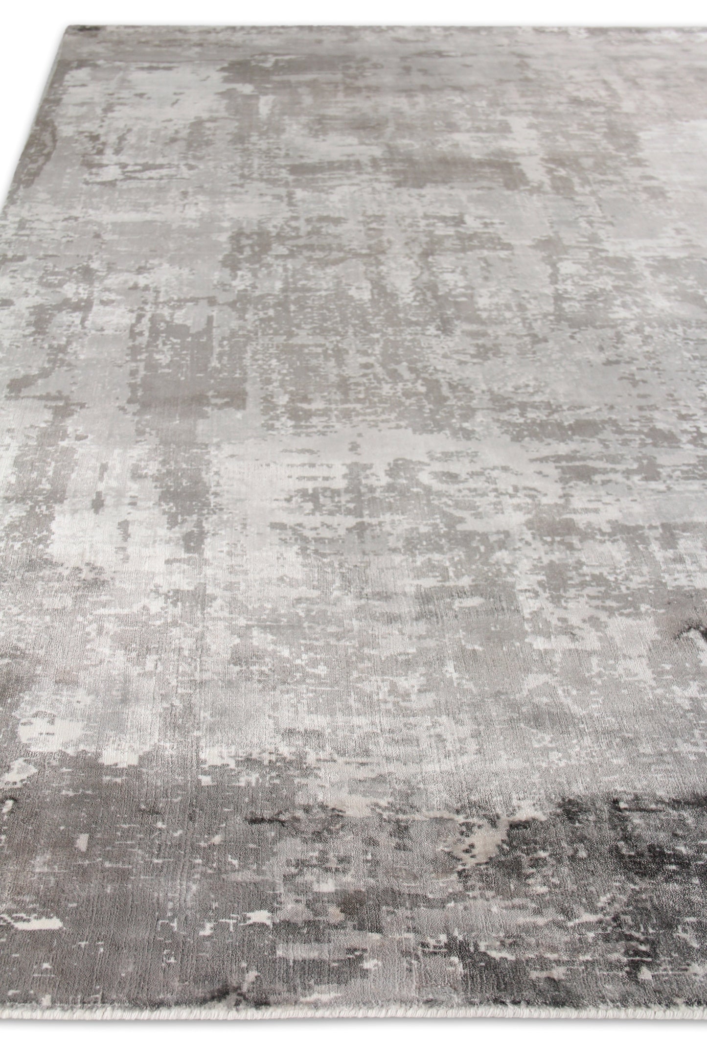 Rectangular gray distressed area rug with silver-charcoal tones and fringe edge.
