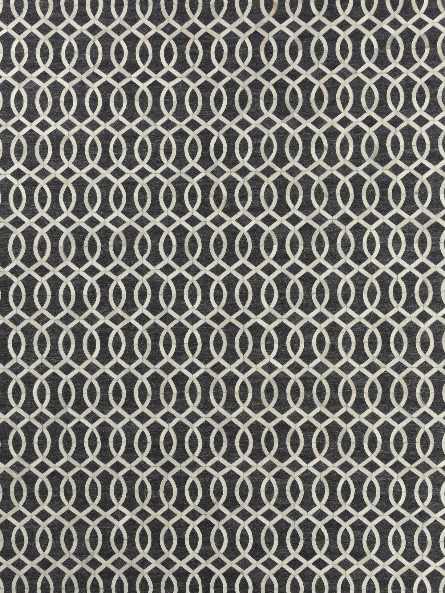 Navy rug featuring a white geometric pattern of interlinked ovals; hand-stitched rectangle rug, ideal for floor decor.