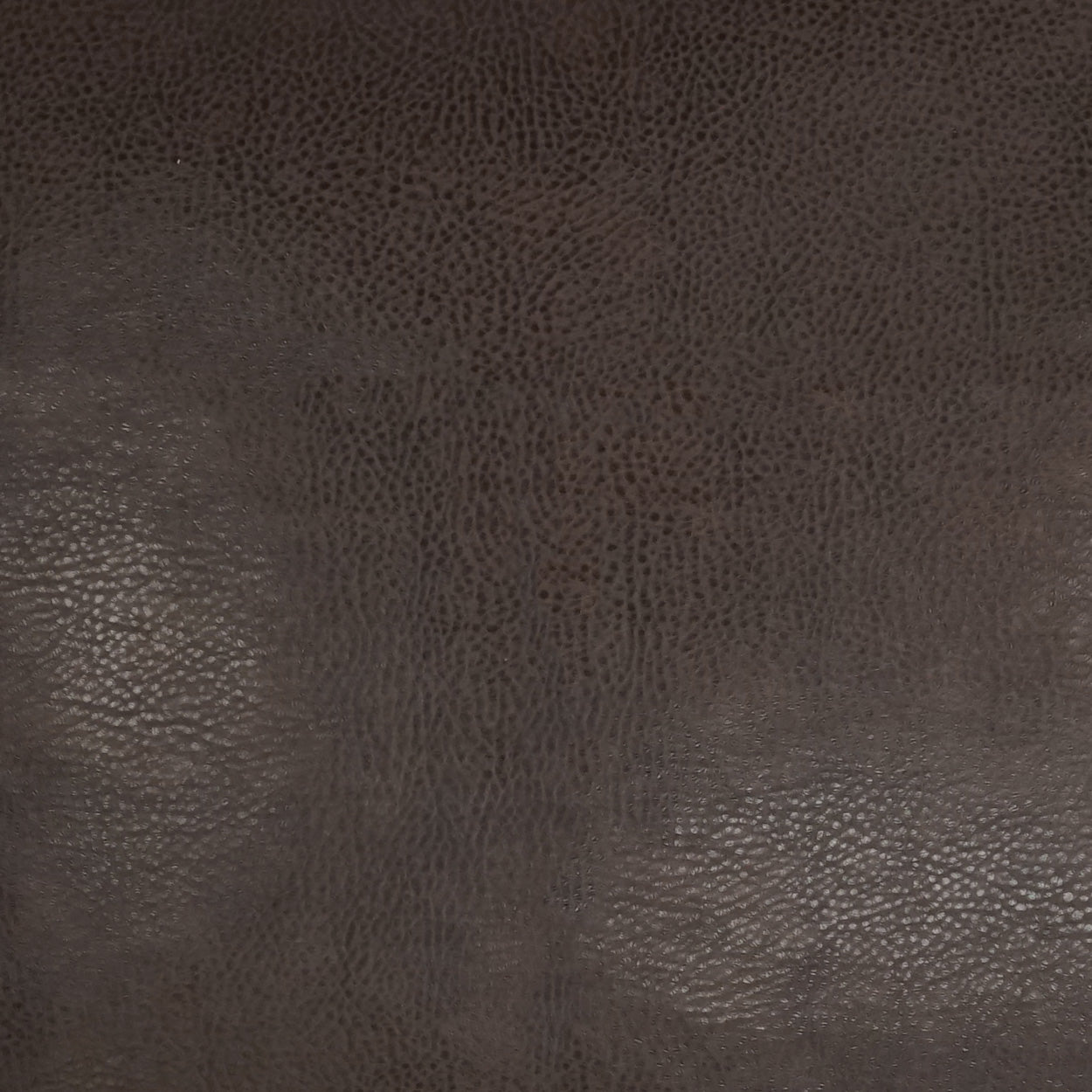 Dark brown pebbled leather texture close-up; versatile leather material for upholstery, bags, or wallets.