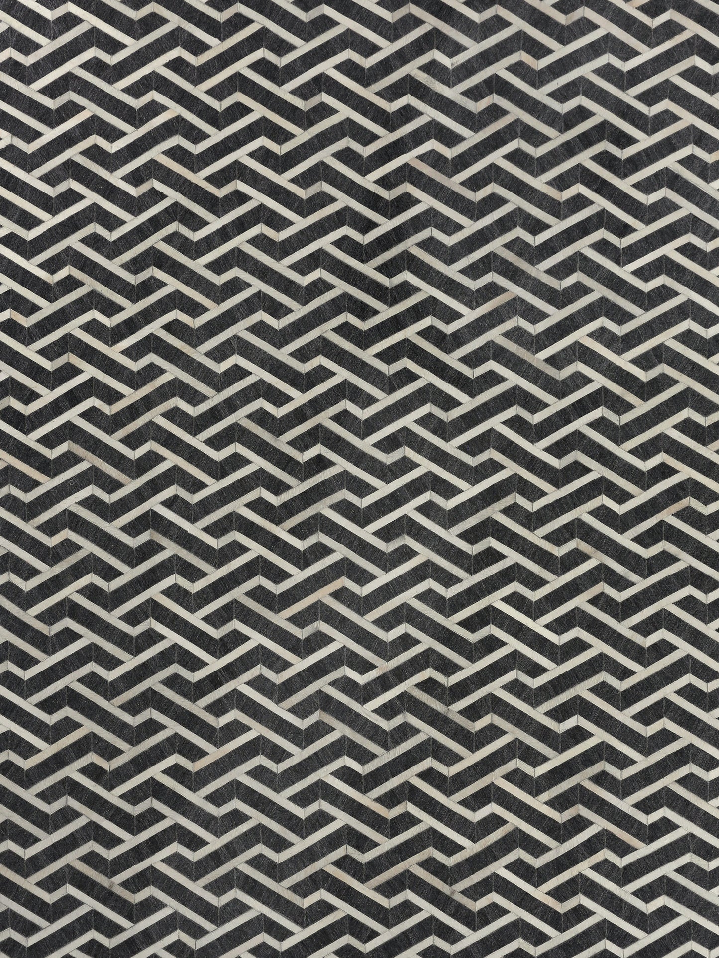 Geometric pattern featuring interlocking black and white lines creating a textured, 3D effect, ideal for modern decor.
