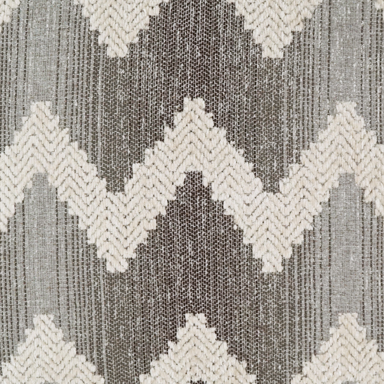 Neutral gray and cream chevron woven fabric; textured textile for upholstery or rug.