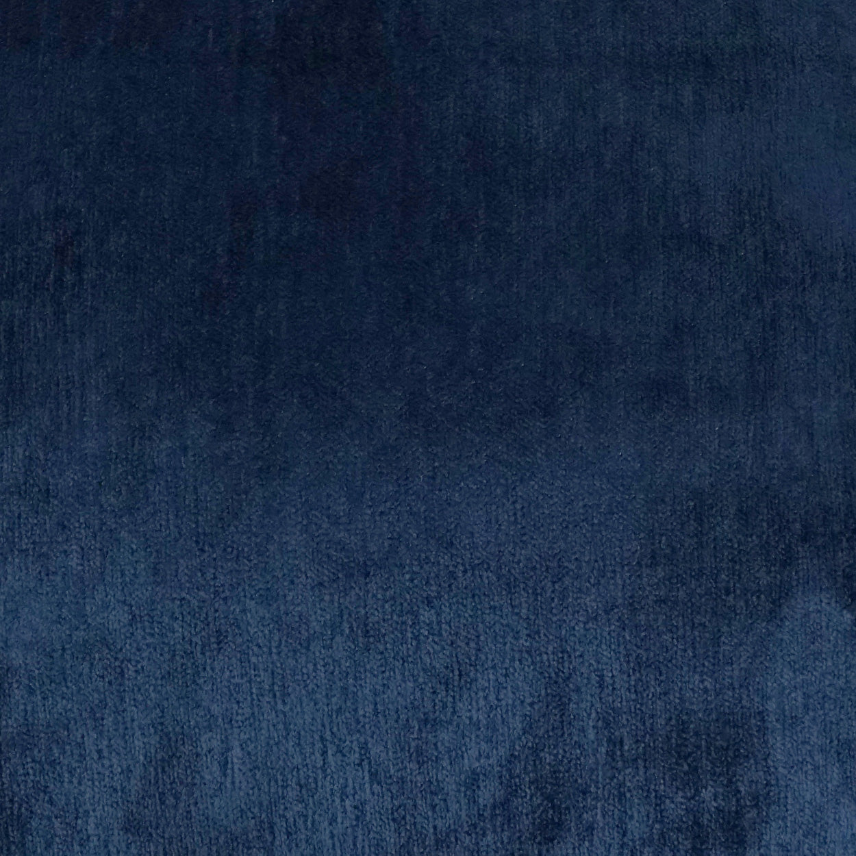 Deep navy velvet fabric texture with soft nap on a 24 x 24 inch cuddle pillow; indigo solid.