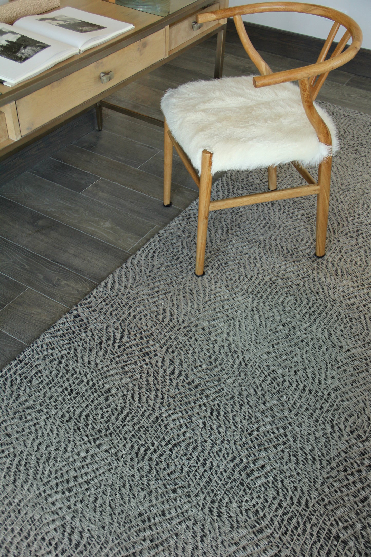 Leopard-print rug on the floor beside a desk, with a light wood chair nearby.