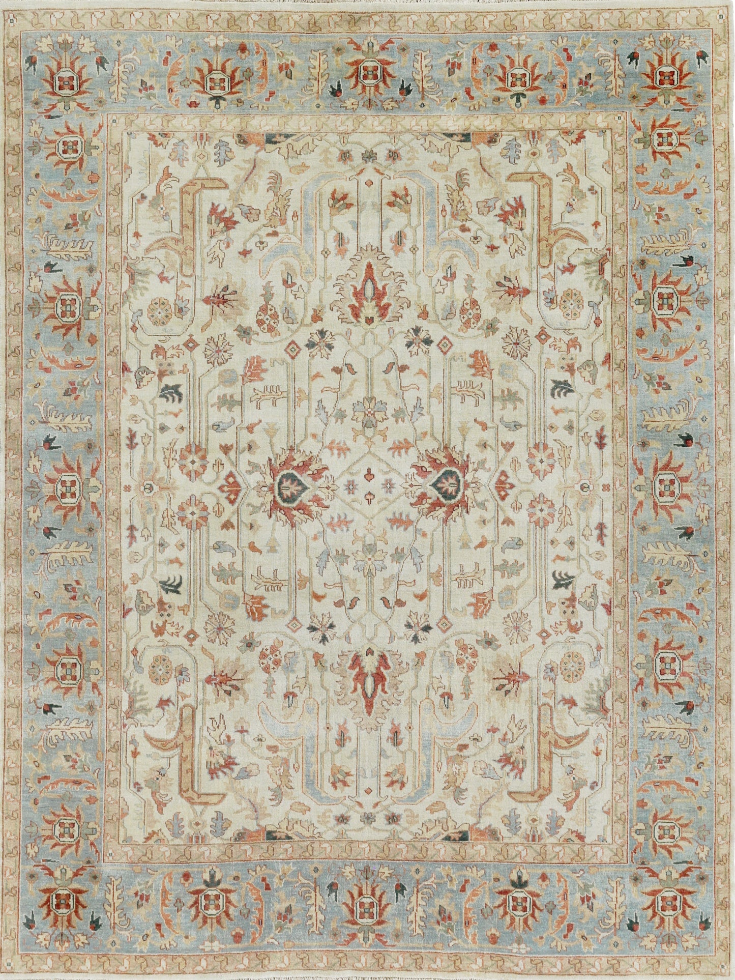 Intricate area rug featuring a floral pattern in soft blues, reds, and cream, with ornate borders and a traditional style.
