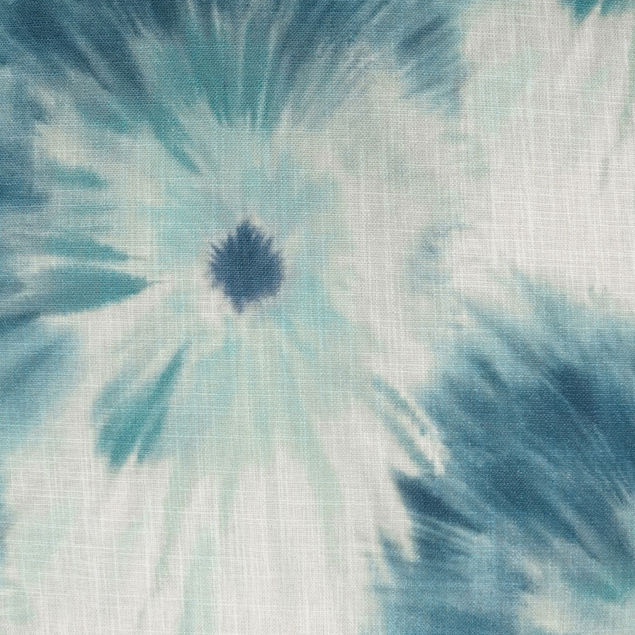 Teal and white tie-dye spiral on a woven fabric with a dark navy center; textured cotton-like material.