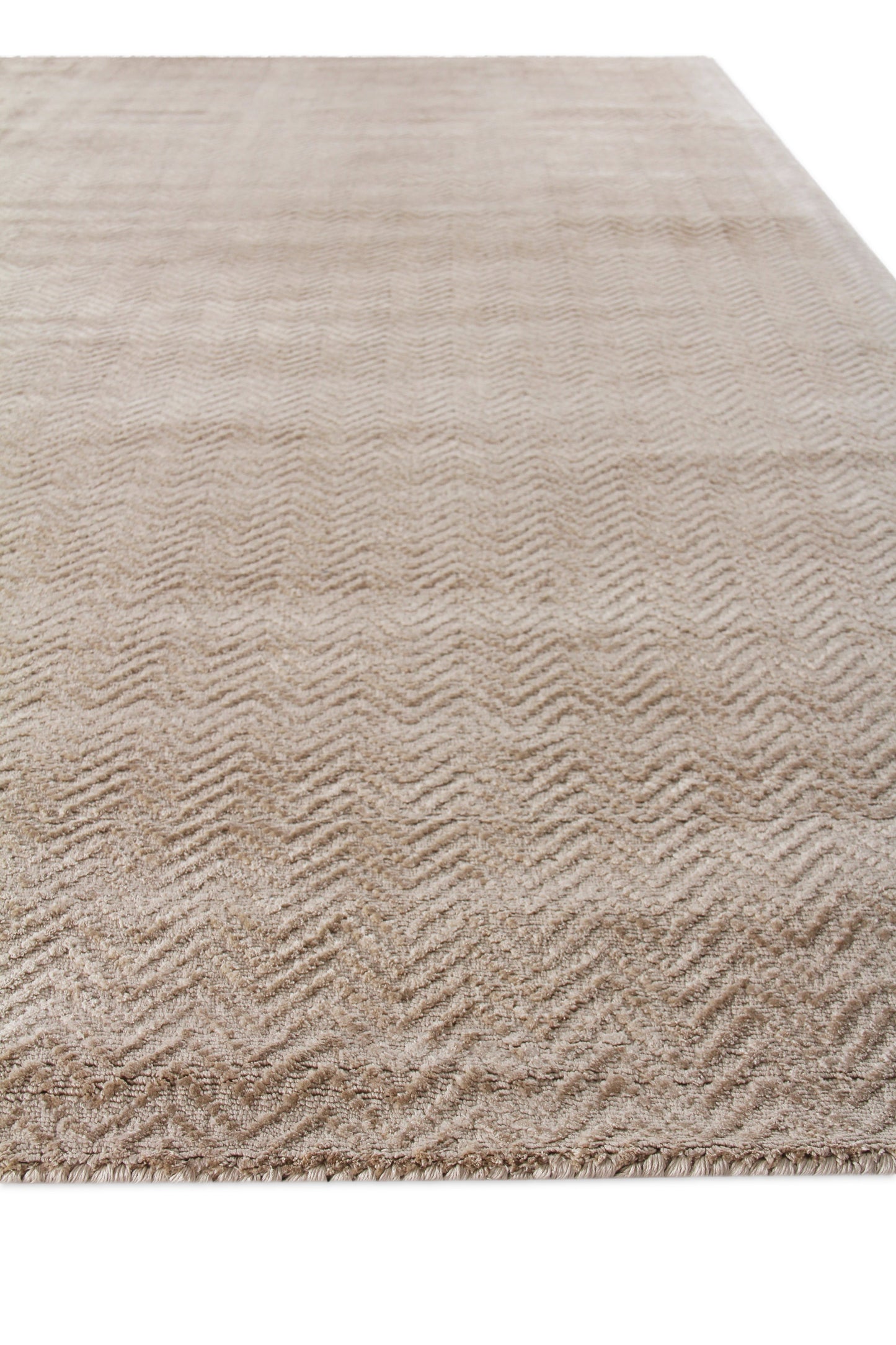 Beige rectangular area rug with subtle chevron/herringbone pattern, soft low-pile, neutral living-room rug.
