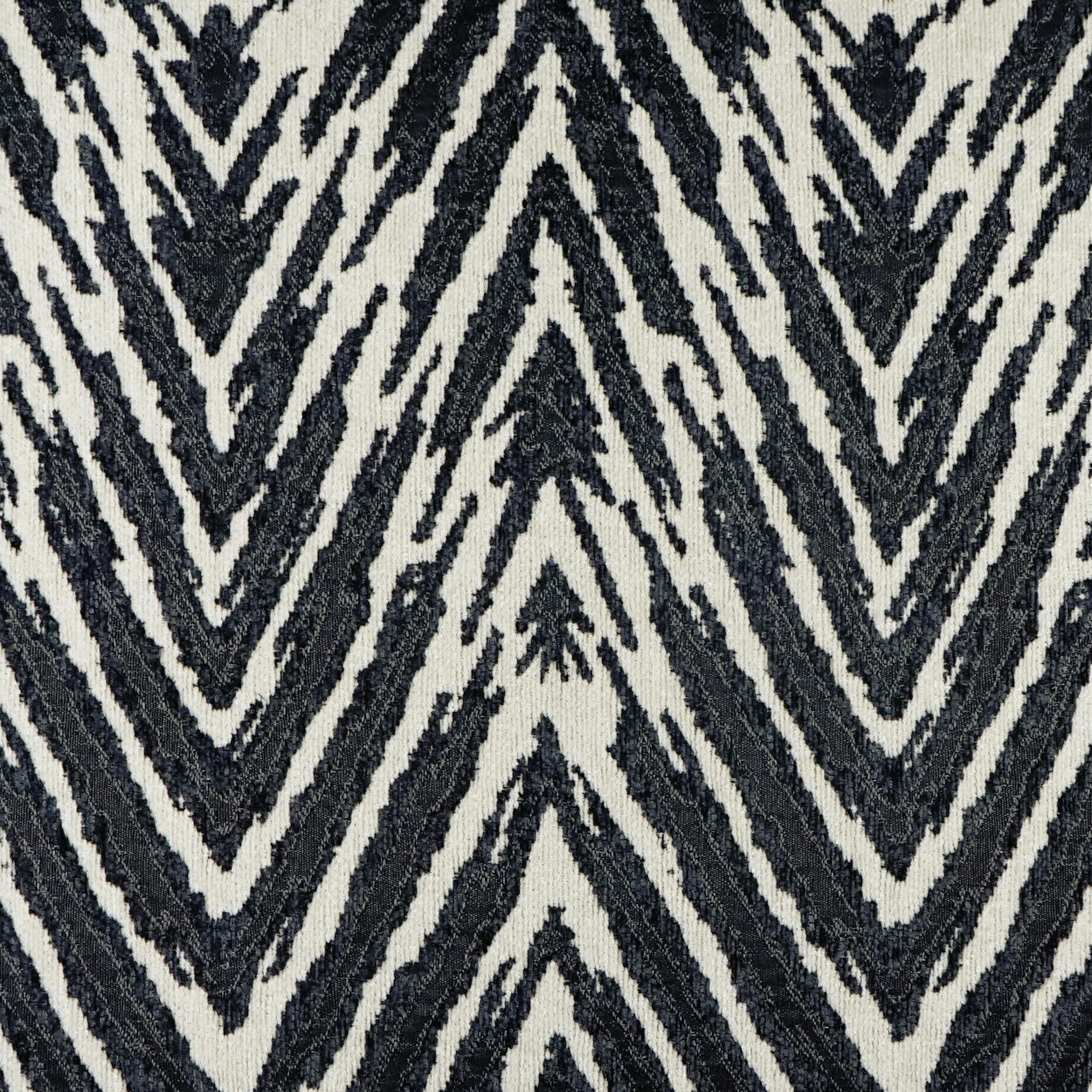 Black and ivory chevron zigzag fabric texture; bold geometric pattern for upholstery or decor.
