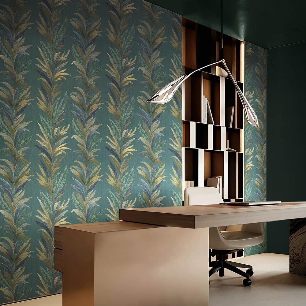 Teal botanical wallpaper with green and blue embossed leaf pattern, light wood desk, wall bookshelf, white office chair & curved pendant lamp.