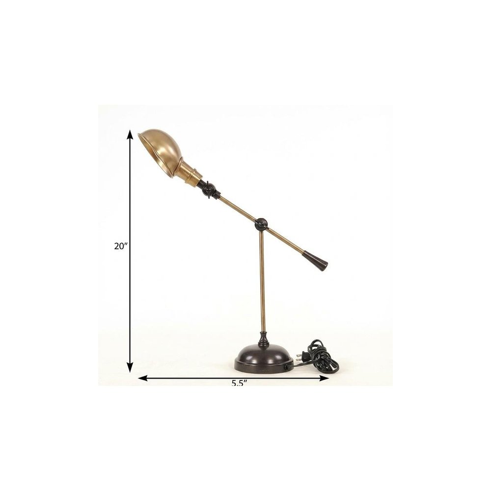 Brass adjustable desk lamp with a dome shade on a round black base; vintage banker-style task lighting.