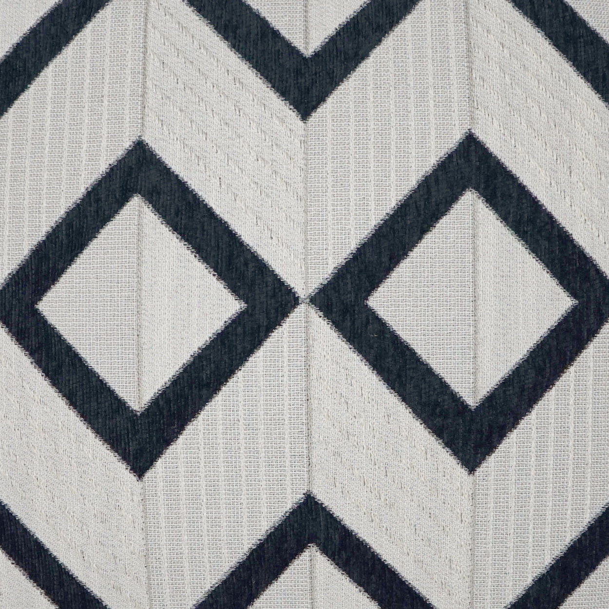 Geometric diamond chevron fabric with light beige background, dark navy diamond outlines, and vertical ribbed texture.