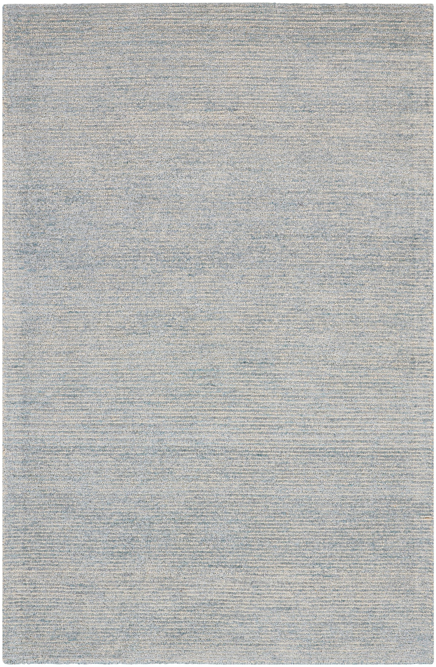 Rectangular light blue-gray rug with subtle woven texture and modern, muted tones.
