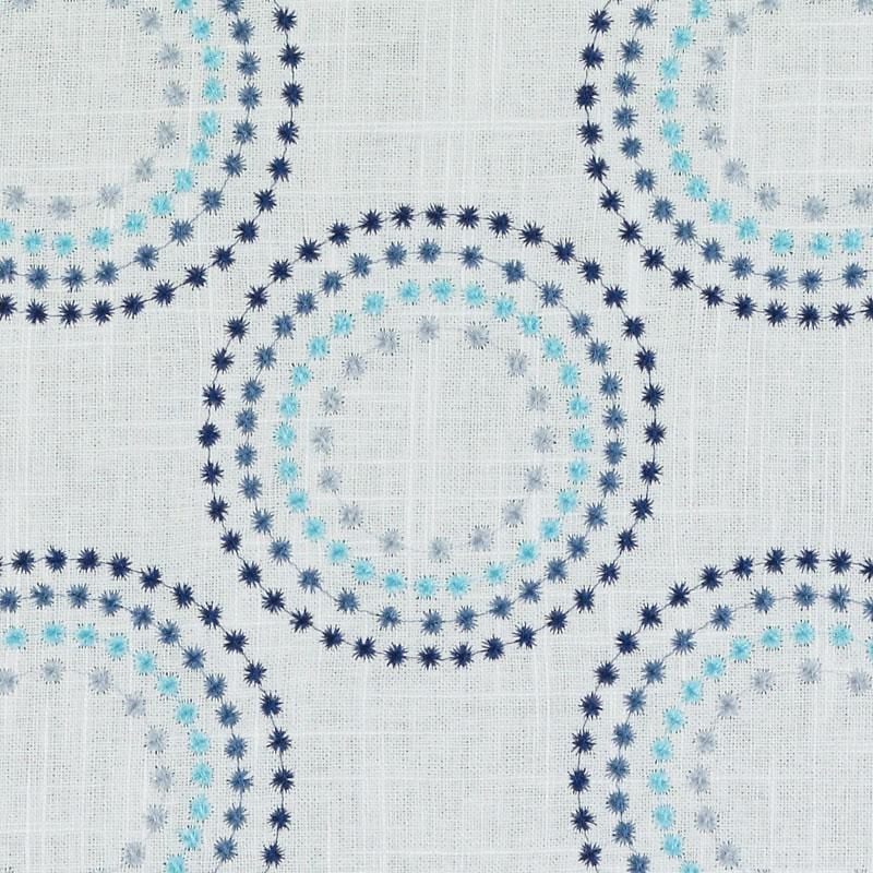 Blue/turquoise drapery fabric with circular rings of navy and sky-blue star-shaped dots.