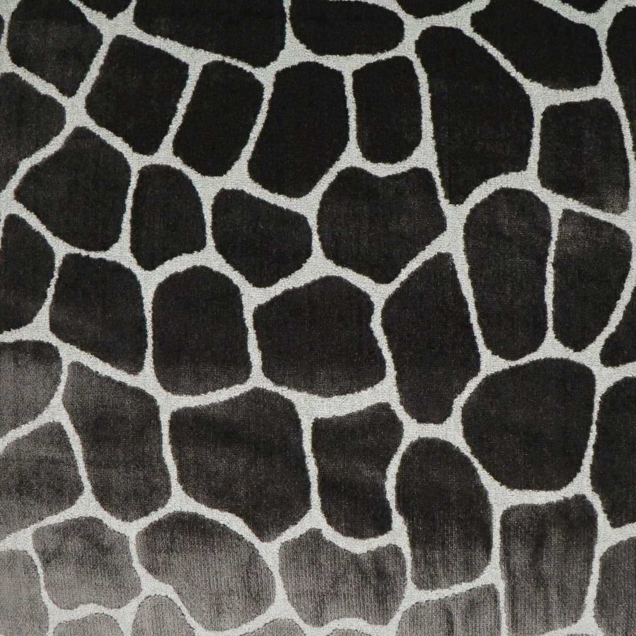 Soft fabric with irregular pebble pattern in dark charcoal and light gray.